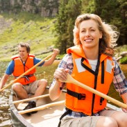 Couple wearing their life jackets while canoeing