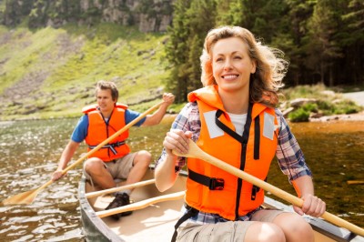 Couple wearing their life jackets while canoeing