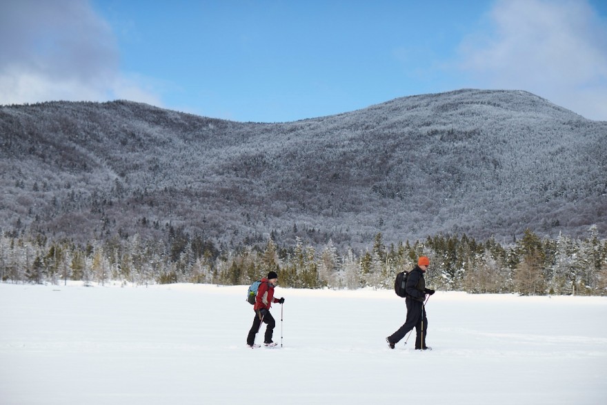 Snowshoers cross a frozen Lonesome Lake.