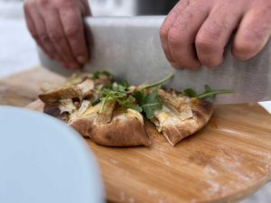 Cutting-Brie-chicken-pizza-photo-by-Suzanne-Downing