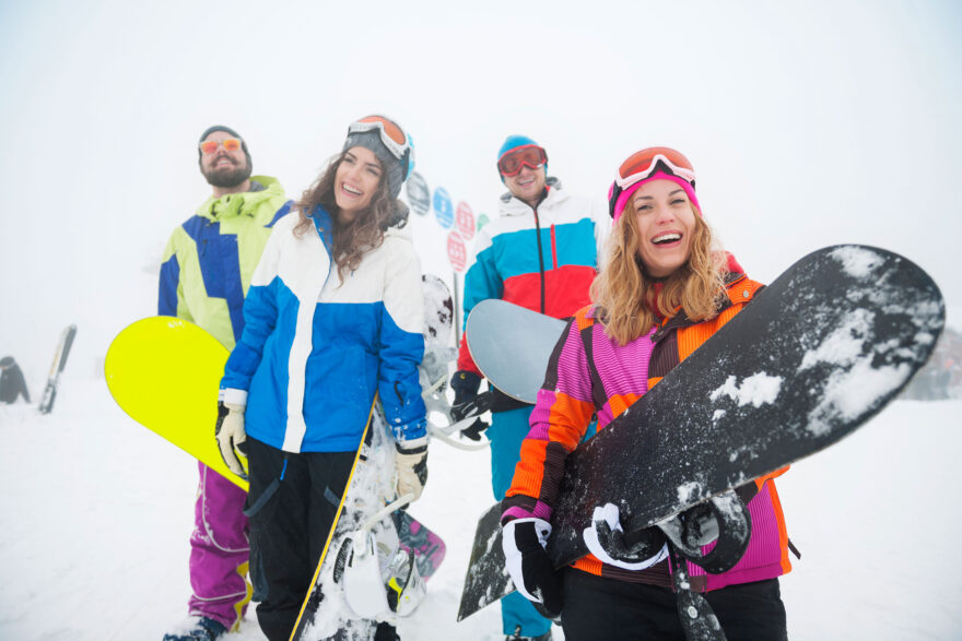 two-couples-having-fun-snowboarding